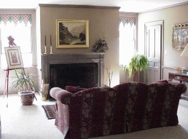 The European Suite has it's own private sitting room with a large sofa in front of a working fireplace
